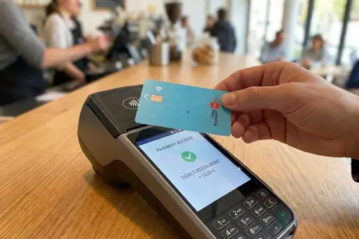 Paiement sans contact par carte titre-restaurant sur un TPE en restauration, avec confirmation de transaction à l'écran